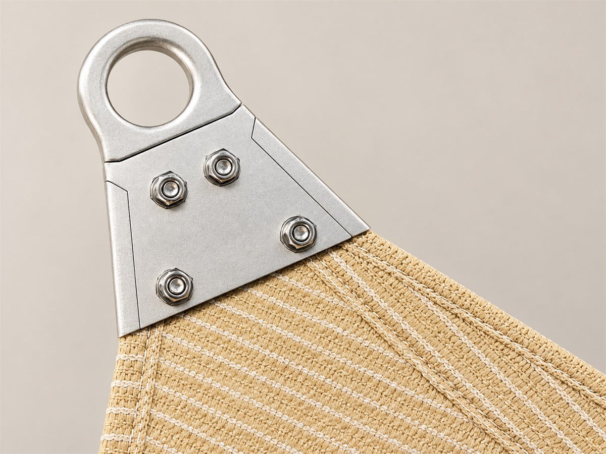 Silver Super Ring corner with four fasteners attached to beige shade fabric.