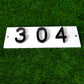 amgo black and white color scheme house number sign in grassy area