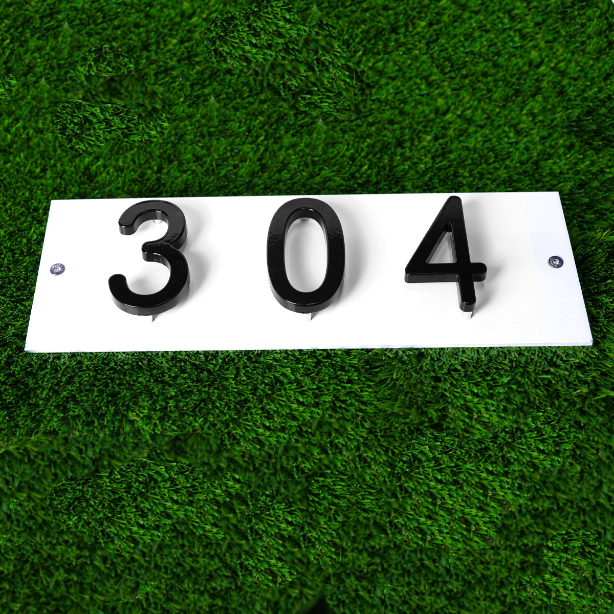 amgo black and white color scheme house number sign in grassy area
